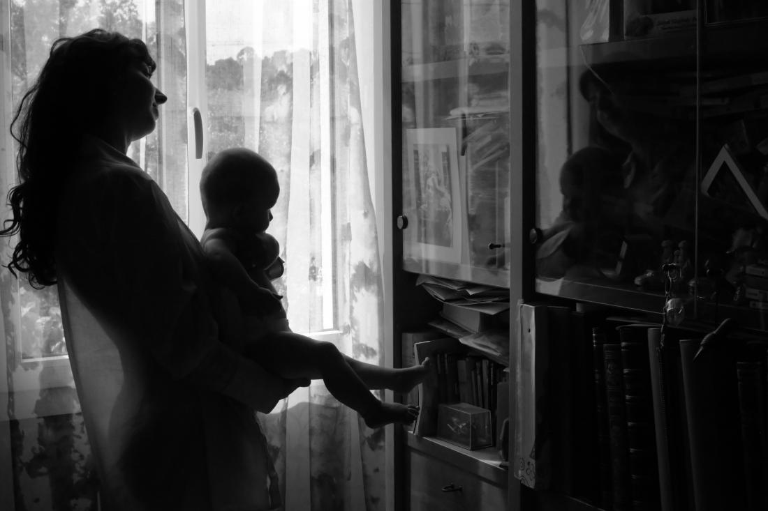 Mother and newborn reflected together, intimacy of the postpartum, black and white