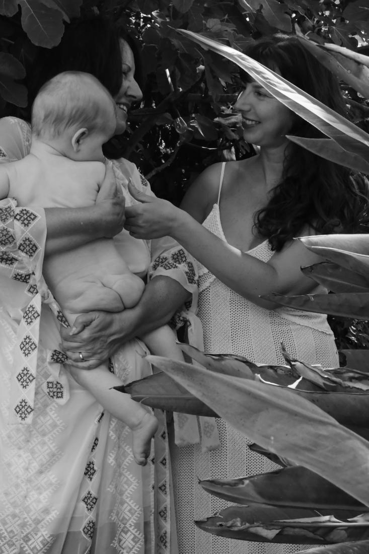 Three generations gathered at a birth: mother, son and grandmother, black and white