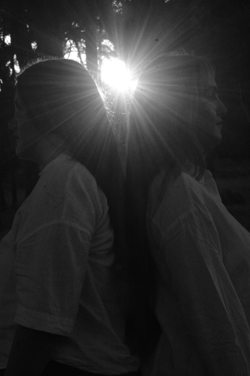 Two close sisters in soft, angelic light, fine-art portrait